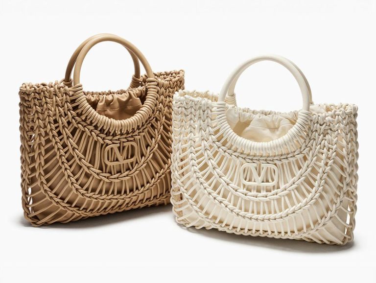 A high-quality replica raffia beach tote with vibrant pom-poms and spacious interior, perfect for summer outings and beach trips.